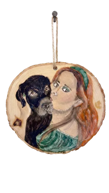 Black dog and a portrait painted on a wood slice