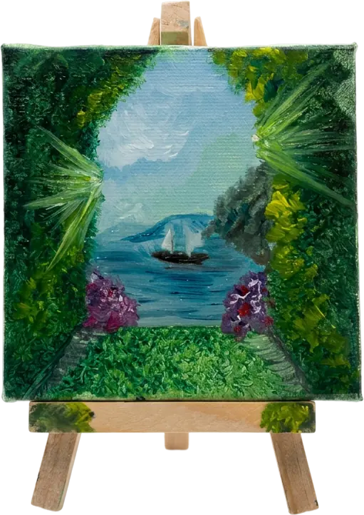 A mini canvas of a sailboat seen through a gap in dense foliage, on a wooden easel